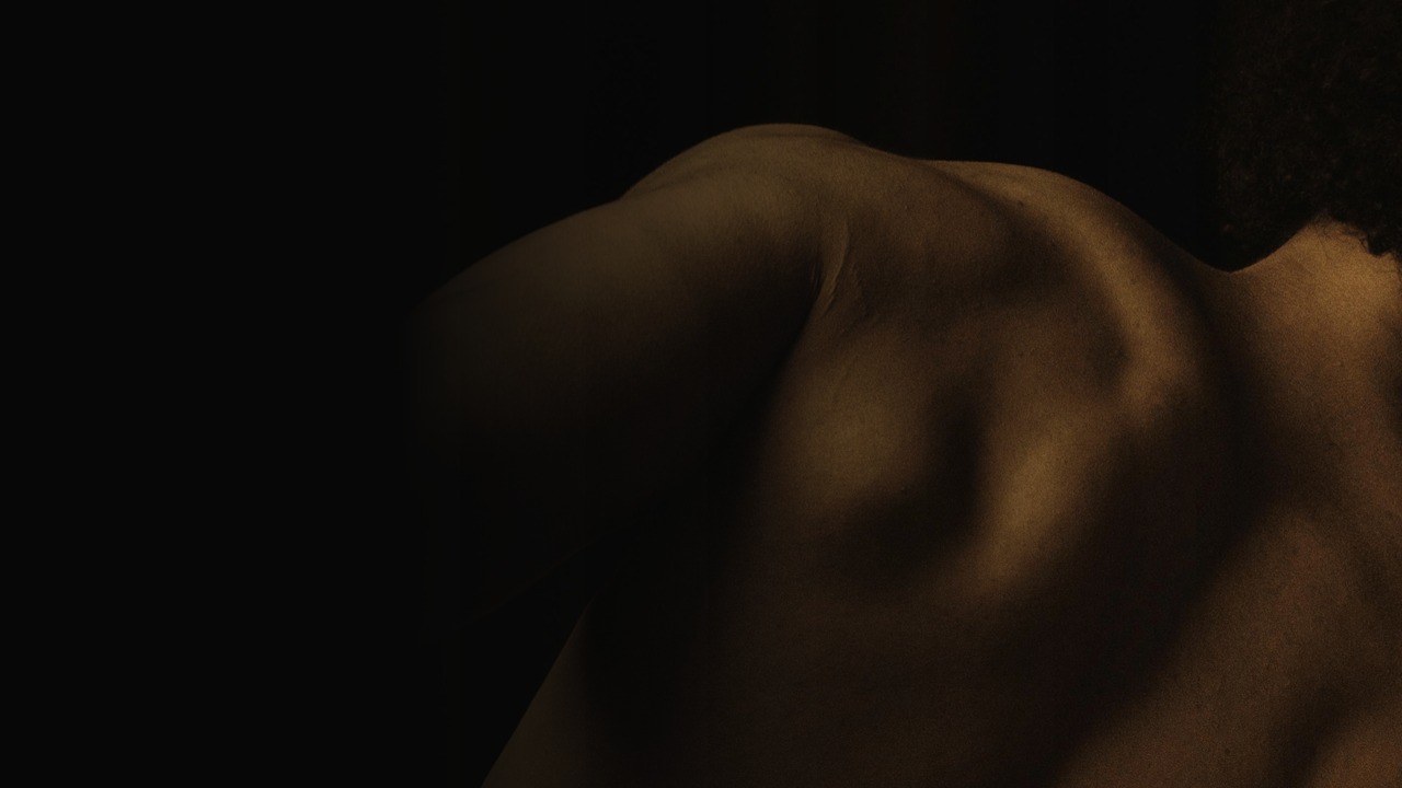 Close view of a human back in warm low light